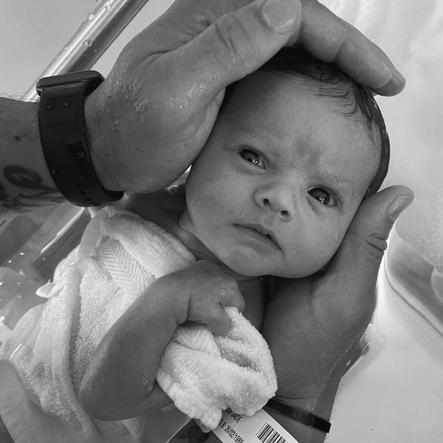 baby in dad's hands