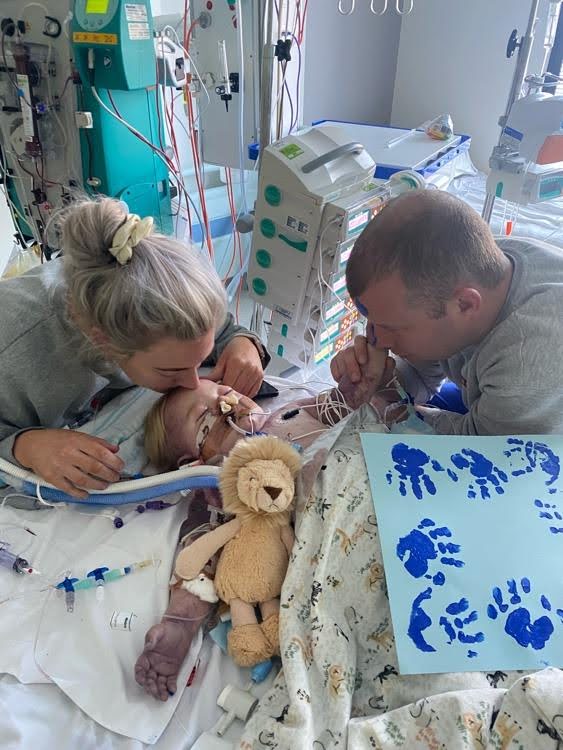 Archie with his parents in hospital